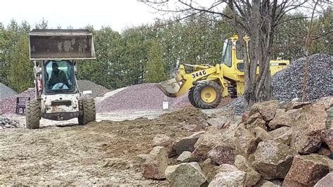 Bobcat S250 Skid Steer Moving Large Rocks 